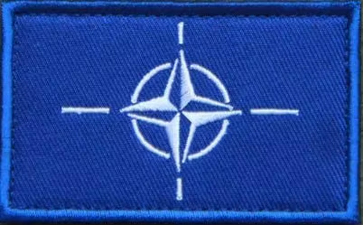 NATO tactical badge with reflective details, crafted for durability and style.